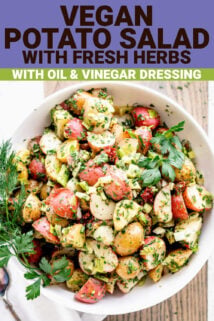 closeup overhead of potato salad in a white bowl with herb sprigs
