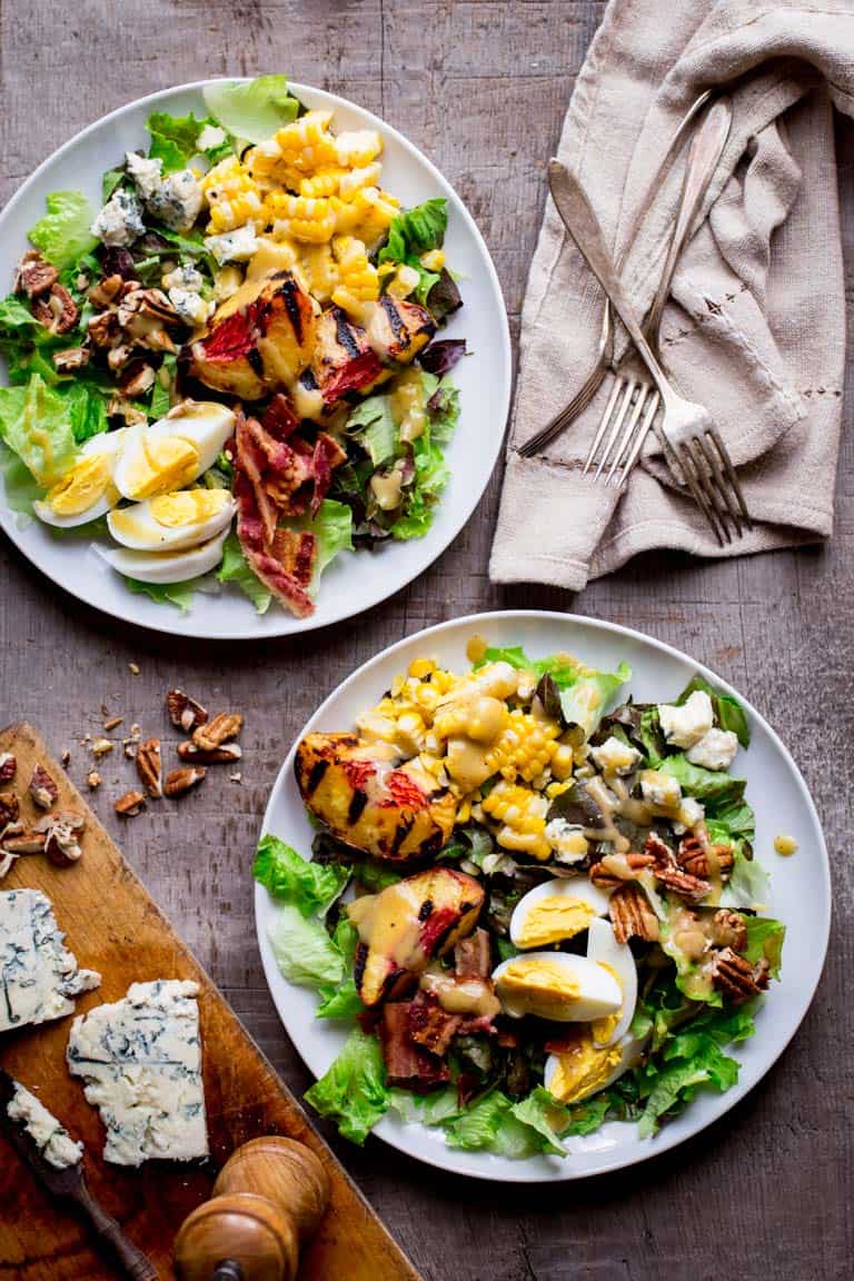 Grilled Corn and Peach Cobb Salad on two serving plates
