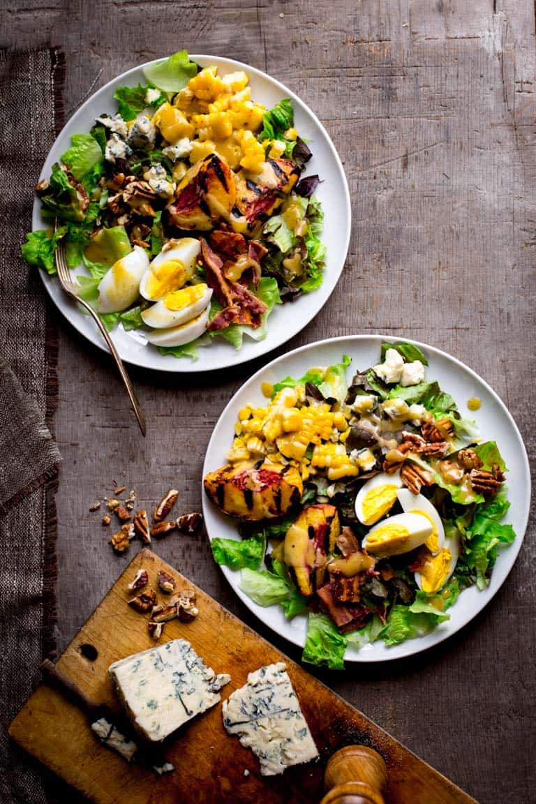 Grilled Corn and Peach Cobb Salad on two serving plates