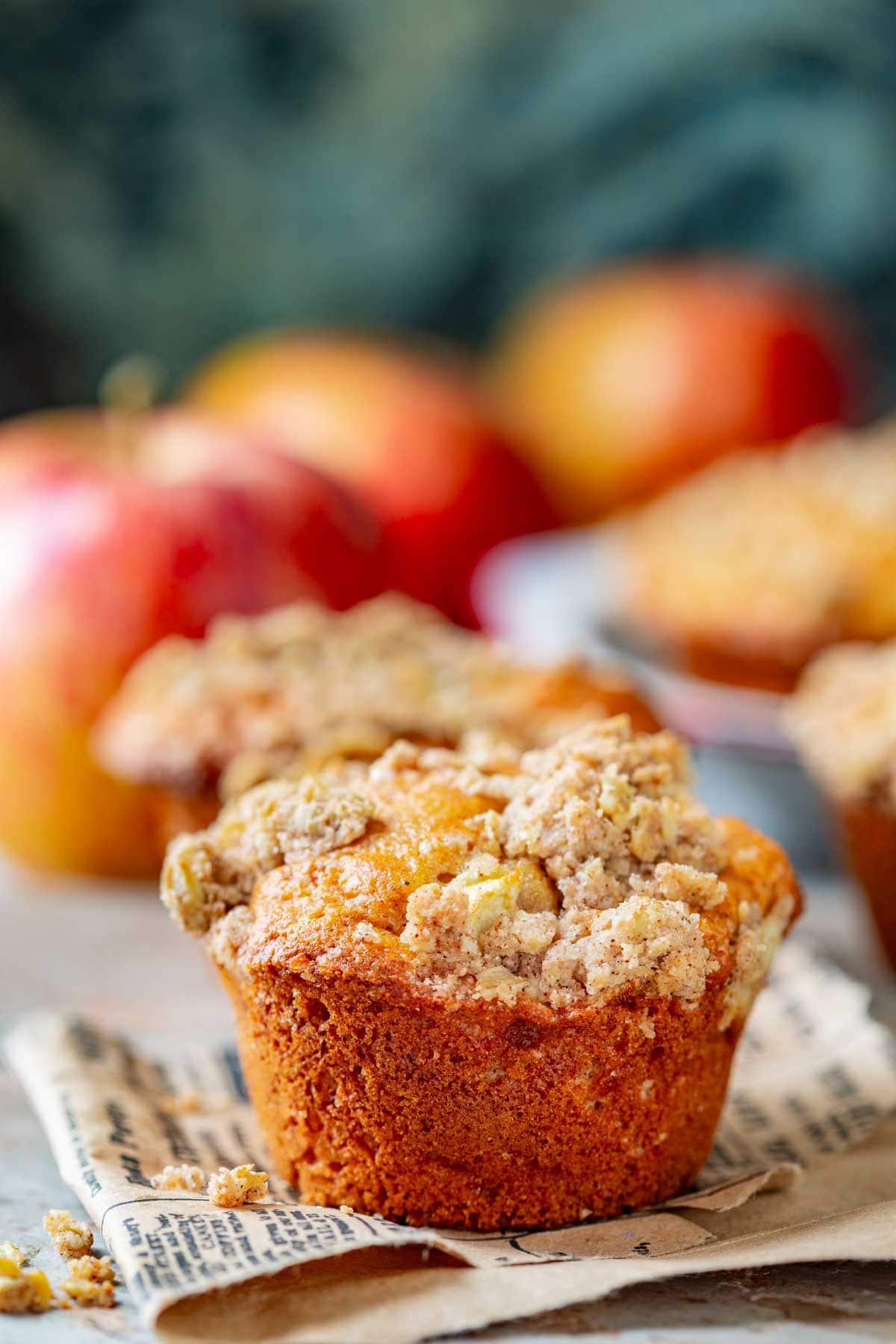 a streusel topped apple muffin up close from the side