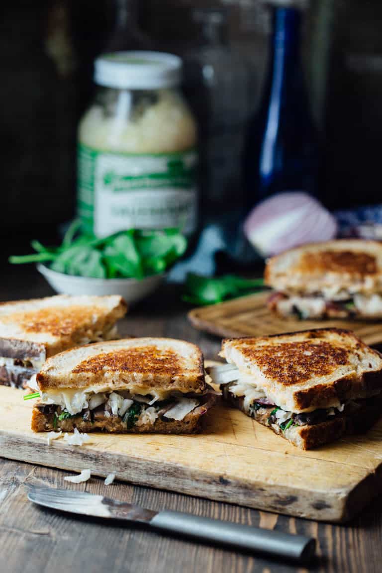 This Skinny Vegetable Reuben is loaded with sautéed mushrooms, onions and spinach, topped with lacto-fermented sauerkraut and sauced with home-made skinny Russian dressing. It is ready in less than 30 minutes for an awesome vegetarian meal the whole family will love! | Healthy Seasonal Recipes | Katie Webster