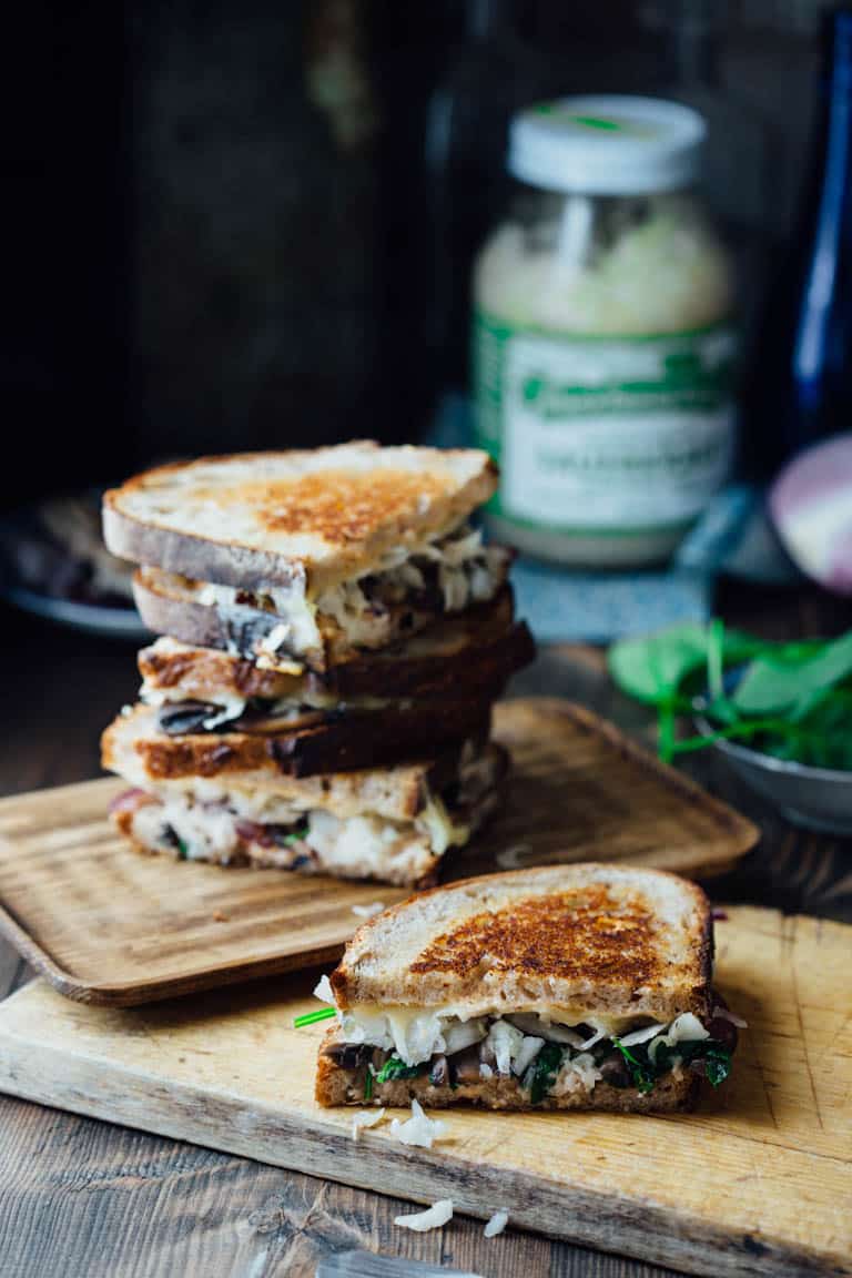 This Skinny Vegetable Reuben is loaded with sautéed mushrooms, onions and spinach, topped with lacto-fermented sauerkraut and sauced with home-made skinny Russian dressing. It is ready in less than 30 minutes for an awesome vegetarian meal the whole family will love! | Healthy Seasonal Recipes | Katie Webster