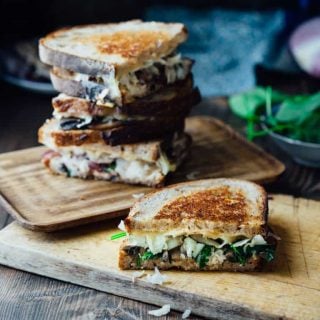 This Skinny Vegetable Reuben is loaded with sautéed mushrooms, onions and spinach, topped with lacto-fermented sauerkraut and sauced with home-made skinny Russian dressing. It is ready in less than 30 minutes for an awesome vegetarian meal the whole family will love! | Healthy Seasonal Recipes | Katie Webster