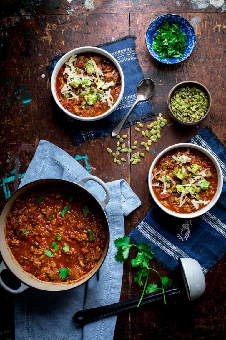 Turkey Chili with Quinoa in serving bowls with pipitas