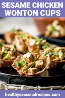 Sesame wonton cups on a black platter