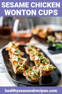 Sesame wonton cups on a black platter
