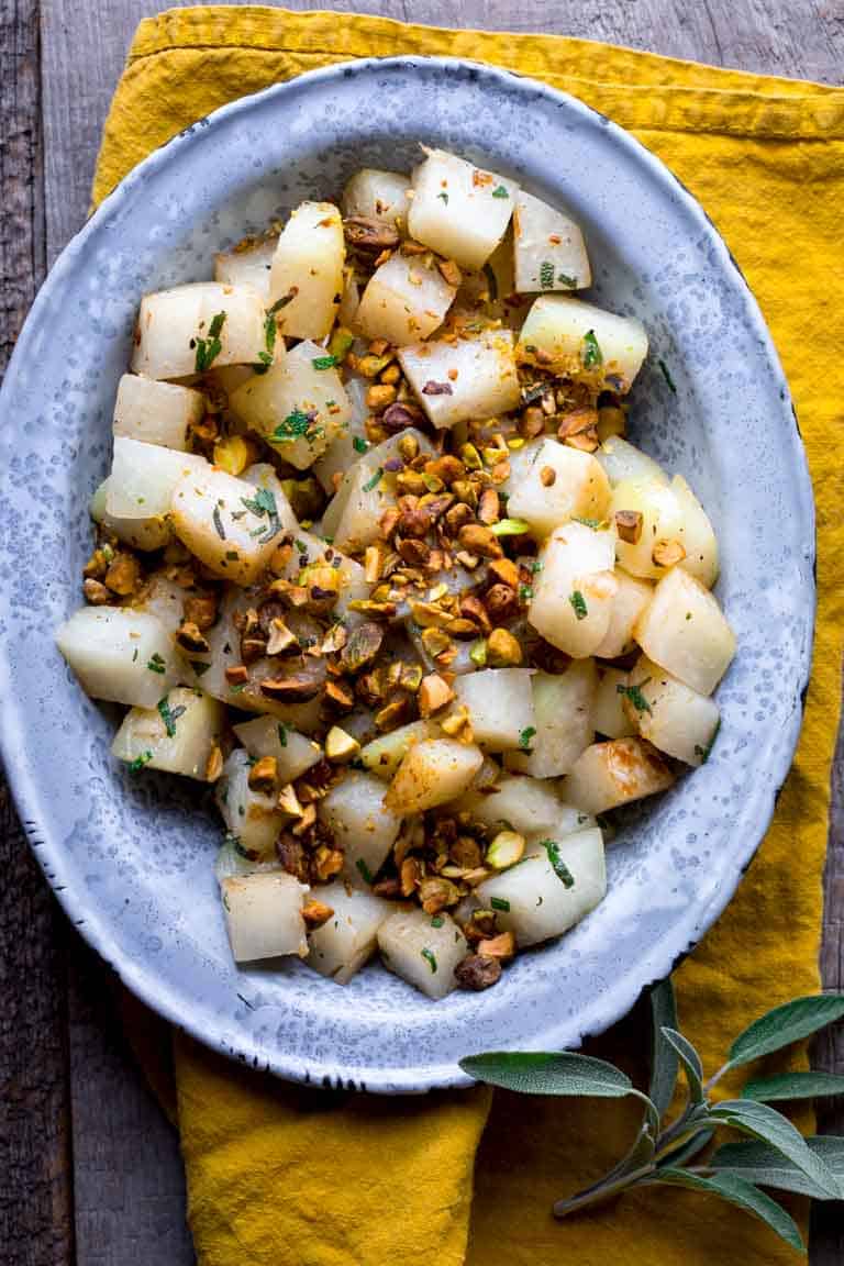 Simple Kohlrabi with Pistachios and Sage on a serving platter