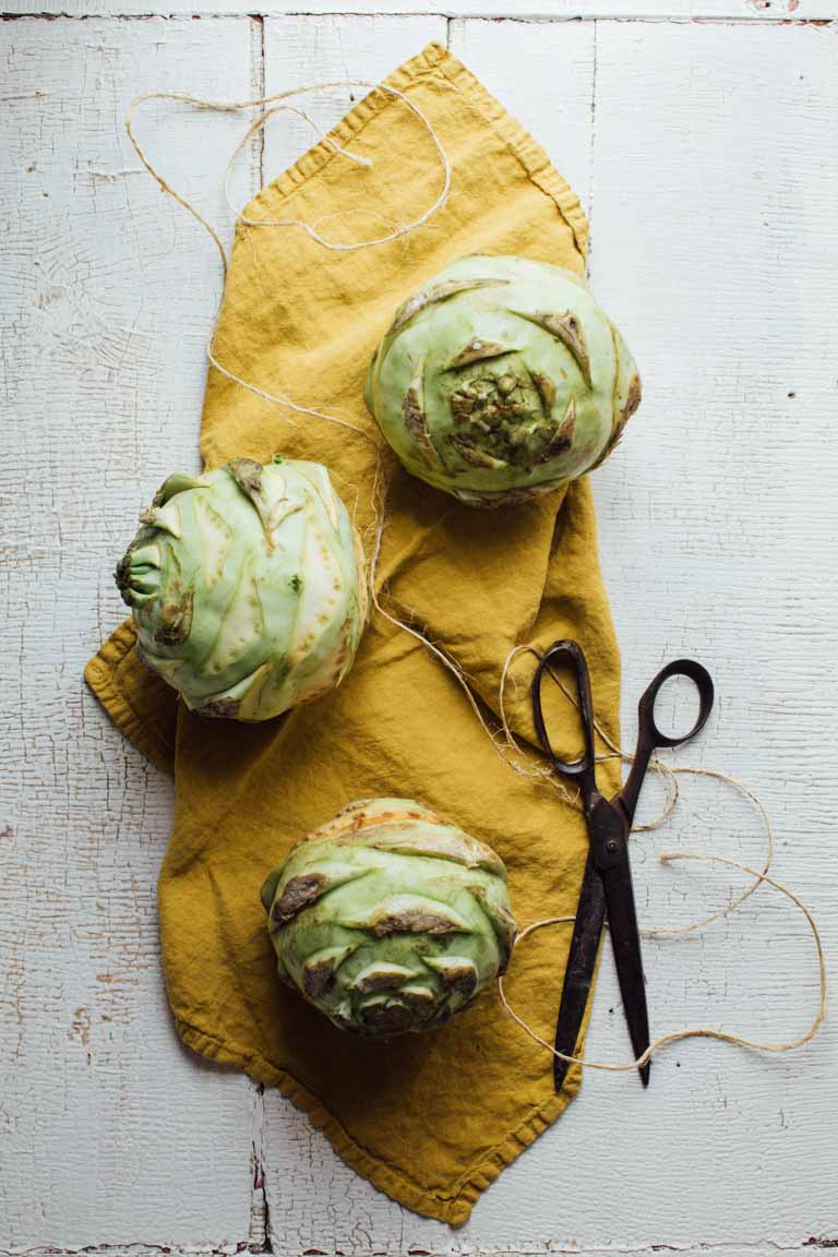 three kohlrabi on a gold napkin