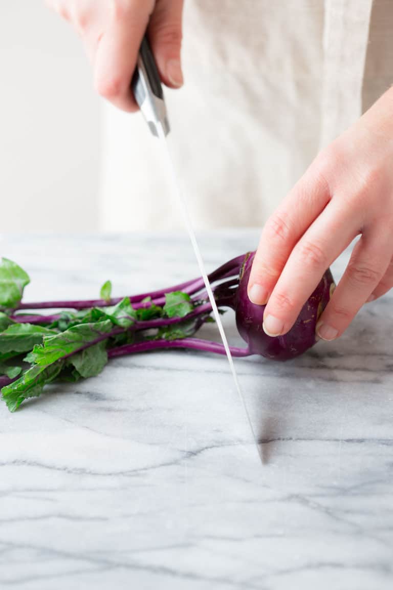cutting stems and leaves off Kohlrabi