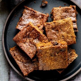 hermit cookies cut into squares on a black plate