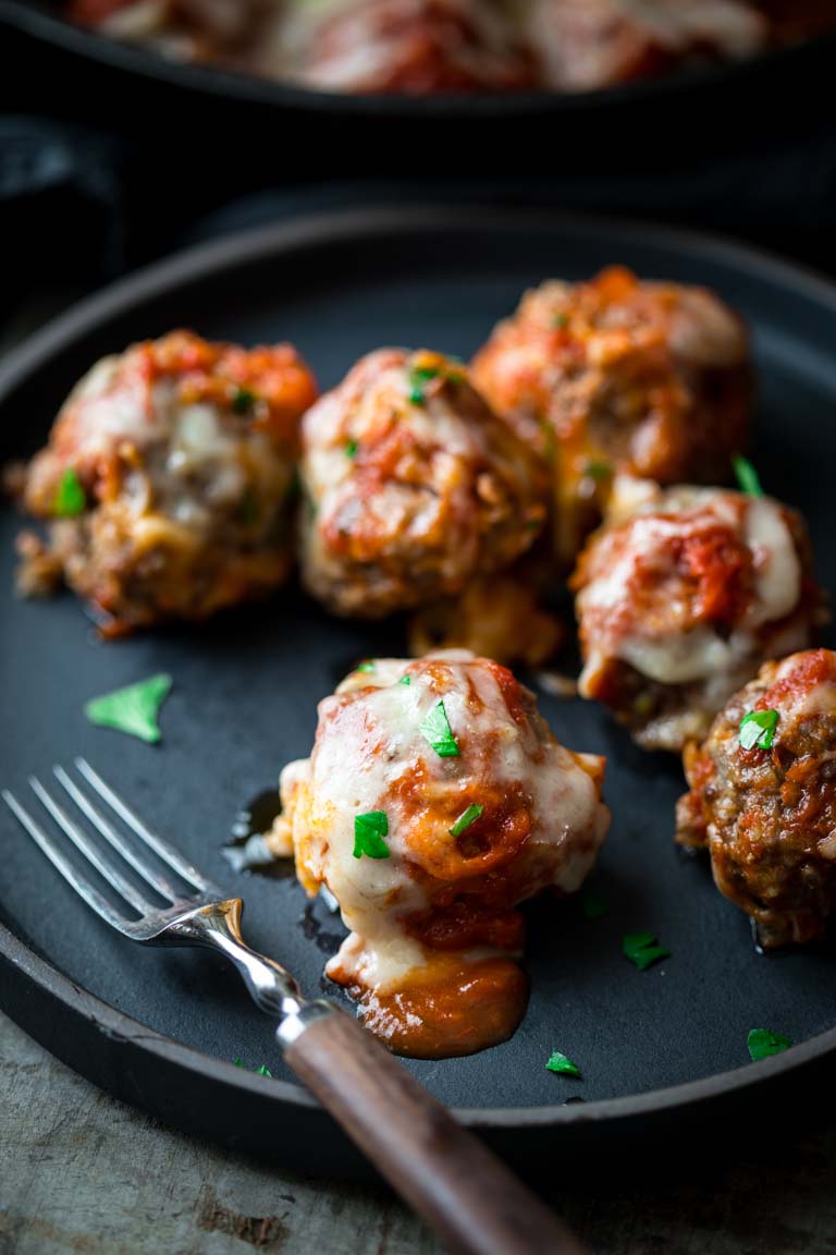 oven baked meatballs with parmesan on a plate