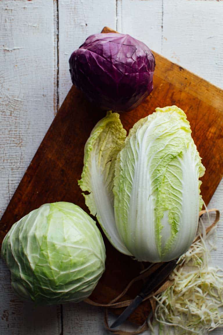 Napa Cabbage, green and red (or purple) cabbage on a cutting board
