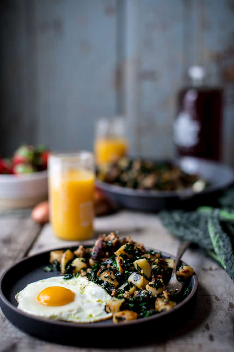 A side shot of Breakfast Hash with Kale with a fried egg