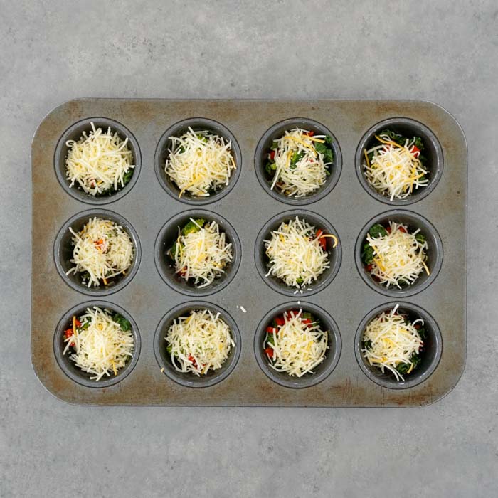 top the veggies with shredded cheddar
