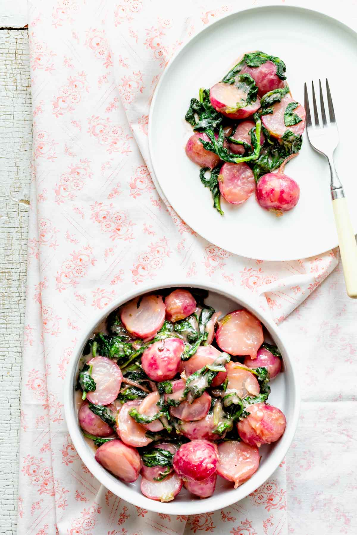 the radish dish in a bowl with a serving on a plate with a fork