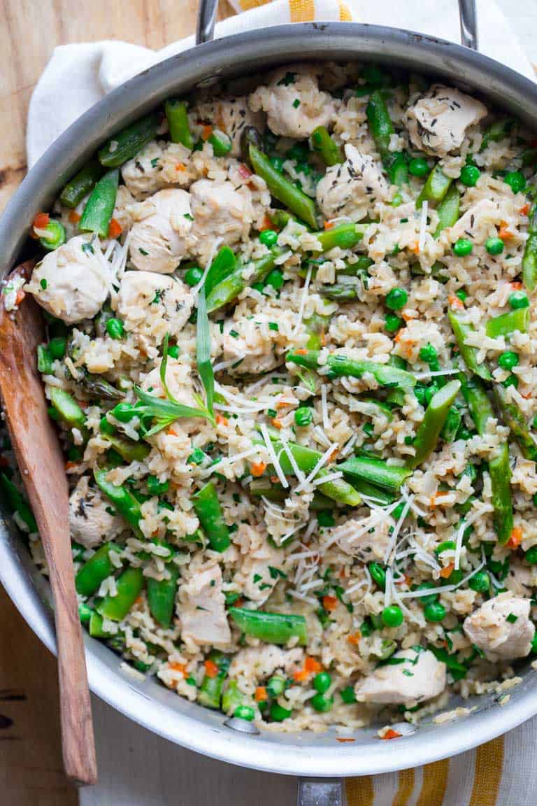 A close up of Chicken and Rice with Spring Veggies in a pot