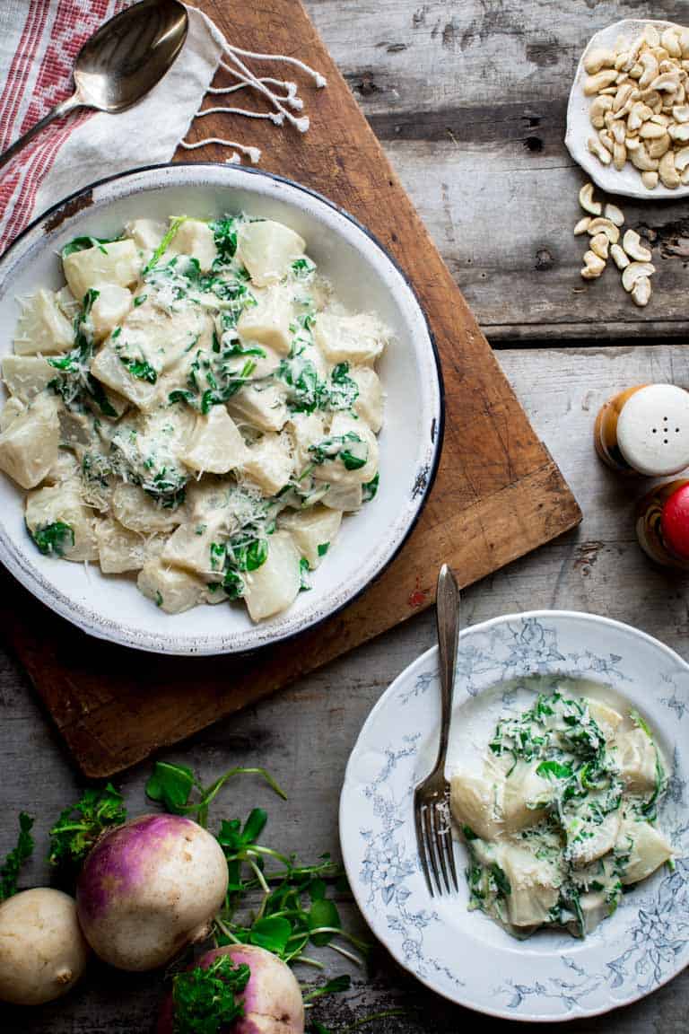 turnip greens and turnips on a plate next to bowl