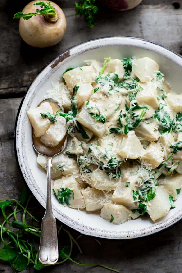 turnips and greens with cashew cream sauce in bowl