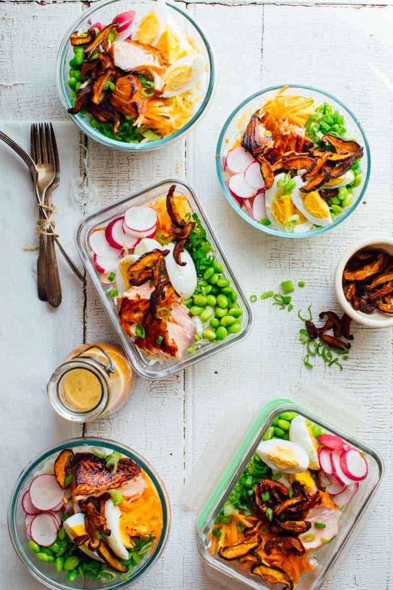 wasabi glazed meal prep salmon in a salad with shiitake mushroom bacon and hard boiled eggs