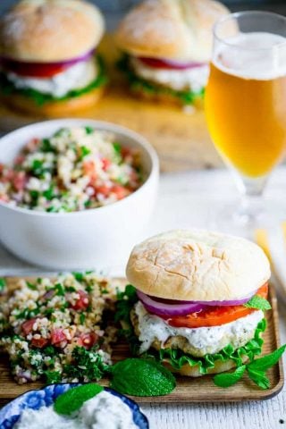 Burgers made from ground chicken, seasoned with za’atar and topped with cucumber mint tzatziki, lettuce and tomato! Get those grills fired up my friends! They’re a middle-eastern flavored burger mash-up you won’t want to miss. Healthy Seasonal Recipes by Katie Webster | #burger #tzatziki #chicken #cucumber #mint #zaatar #grill