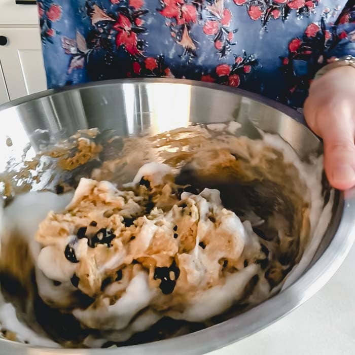 fold the whipped egg whites into the batter to lighten it