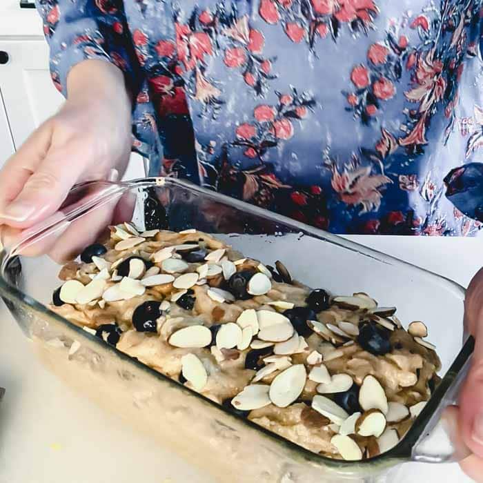 top the loaf with blueberries and almonds