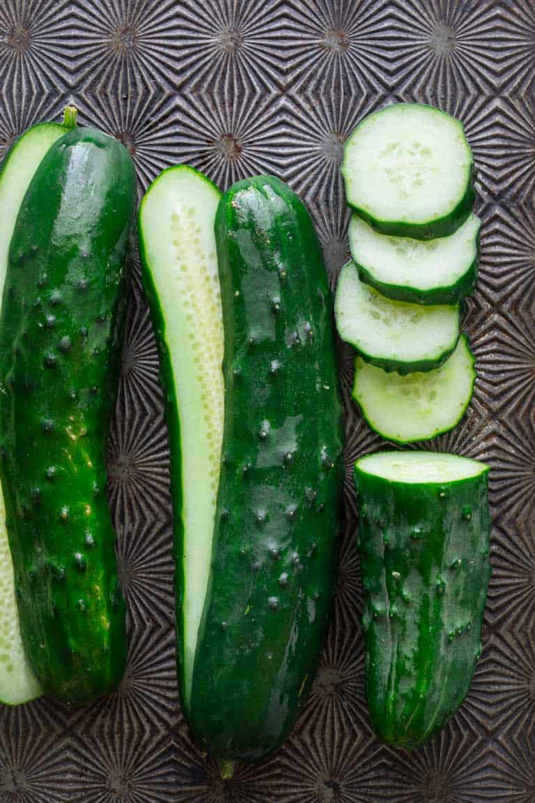 Have you ever wondered about why your cucumbers are bitter? Or whether or not you can freeze cucumbers? And what about how to grow cucumbers? Look no further than this Ultimate Guide to Cucumbers. These crunchy, refreshing veg is popular for good reason. See your questions answered below, along with cucumber recipes for inspiration. Healthy Seasonal Recipes by Katie Webster | #cucumber #summer #produce #fresh #gardening #cooking
