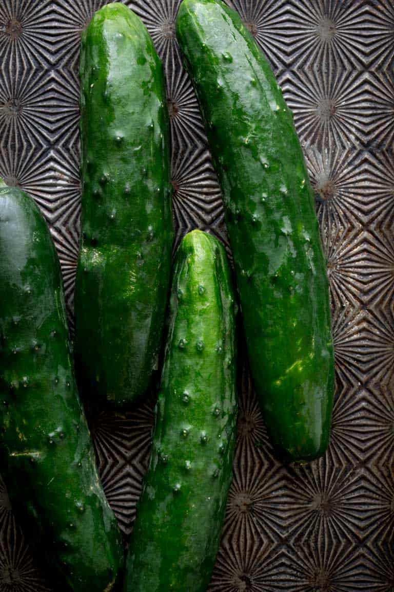 Have you ever wondered about why your cucumbers are bitter? Or whether or not you can freeze cucumbers? And what about how to grow cucumbers? Look no further than this Ultimate Guide to Cucumbers. These crunchy, refreshing veg is popular for good reason. See your questions answered below, along with cucumber recipes for inspiration. Healthy Seasonal Recipes by Katie Webster | #cucumber #summer #produce #fresh #gardening #cooking