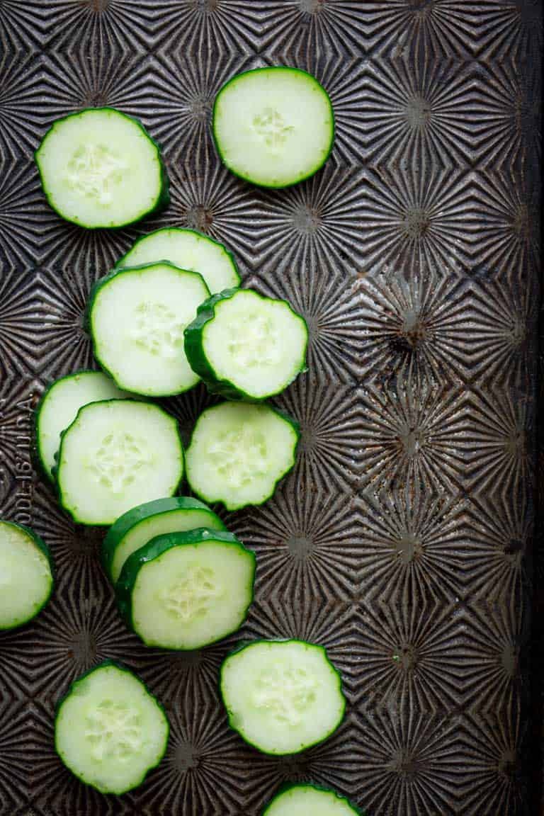 Have you ever wondered about why your cucumbers are bitter? Or whether or not you can freeze cucumbers? And what about how to grow cucumbers? Look no further than this Ultimate Guide to Cucumbers. These crunchy, refreshing veg is popular for good reason. See your questions answered below, along with cucumber recipes for inspiration. Healthy Seasonal Recipes by Katie Webster | #cucumber #summer #produce #fresh #gardening #cooking