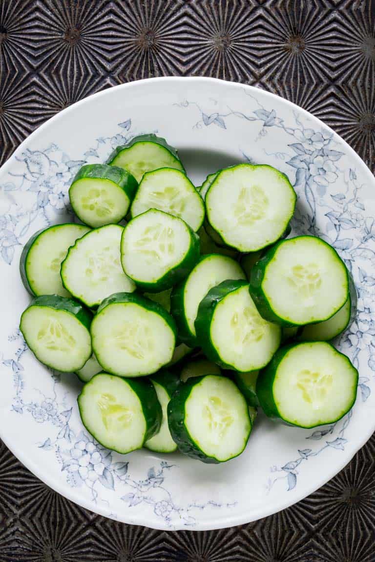 Have you ever wondered about why your cucumbers are bitter? Or whether or not you can freeze cucumbers? And what about how to grow cucumbers? Look no further than this Ultimate Guide to Cucumbers. These crunchy, refreshing veg is popular for good reason. See your questions answered below, along with cucumber recipes for inspiration. Healthy Seasonal Recipes by Katie Webster | #cucumber #summer #produce #fresh #gardening #cooking