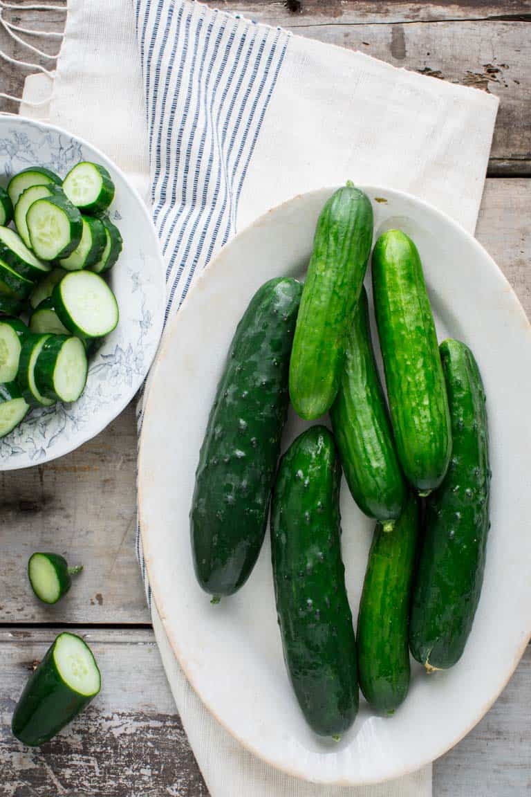 Have you ever wondered about why your cucumbers are bitter? Or whether or not you can freeze cucumbers? And what about how to grow cucumbers? Look no further than this Ultimate Guide to Cucumbers. These crunchy, refreshing veg is popular for good reason. See your questions answered below, along with cucumber recipes for inspiration. Healthy Seasonal Recipes by Katie Webster | #cucumber #summer #produce #fresh #gardening #cooking