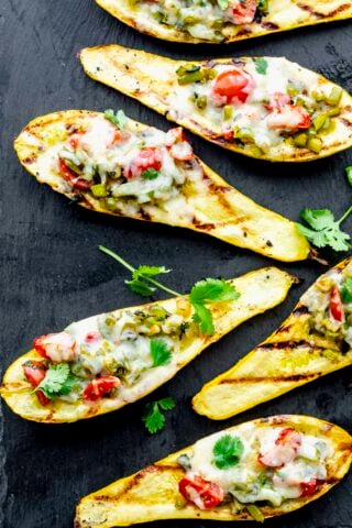 the grilled stuffed summer squash on a black slate