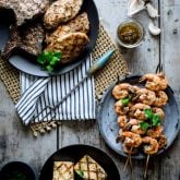 garlic marinade in a jar on a cutting board with grilled chicken