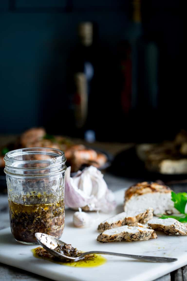 A jar of garlic marinade from the side