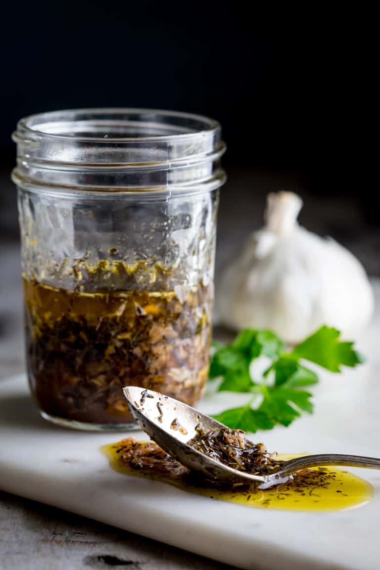 A jar of garlic marinade from the side