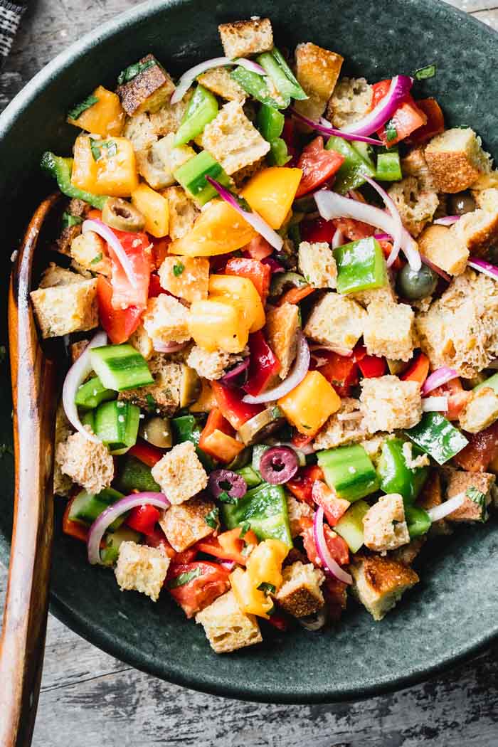 Overhead of a teal bowl filled with panzanella