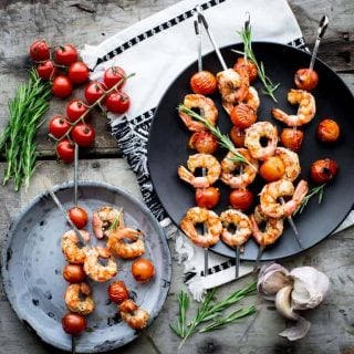 Nothing says summer like these rosemary shrimp and tomato kebabs. Fire up the grill this summer and enjoy these savory, buttery bites. Better yet, clean up is quick and easy! Great for weeknights with your family. Healthy Seasonal Recipes by Katie Webster | #summer #familyfriendly #kebab #savory #shrimp #tomato #quick #easy