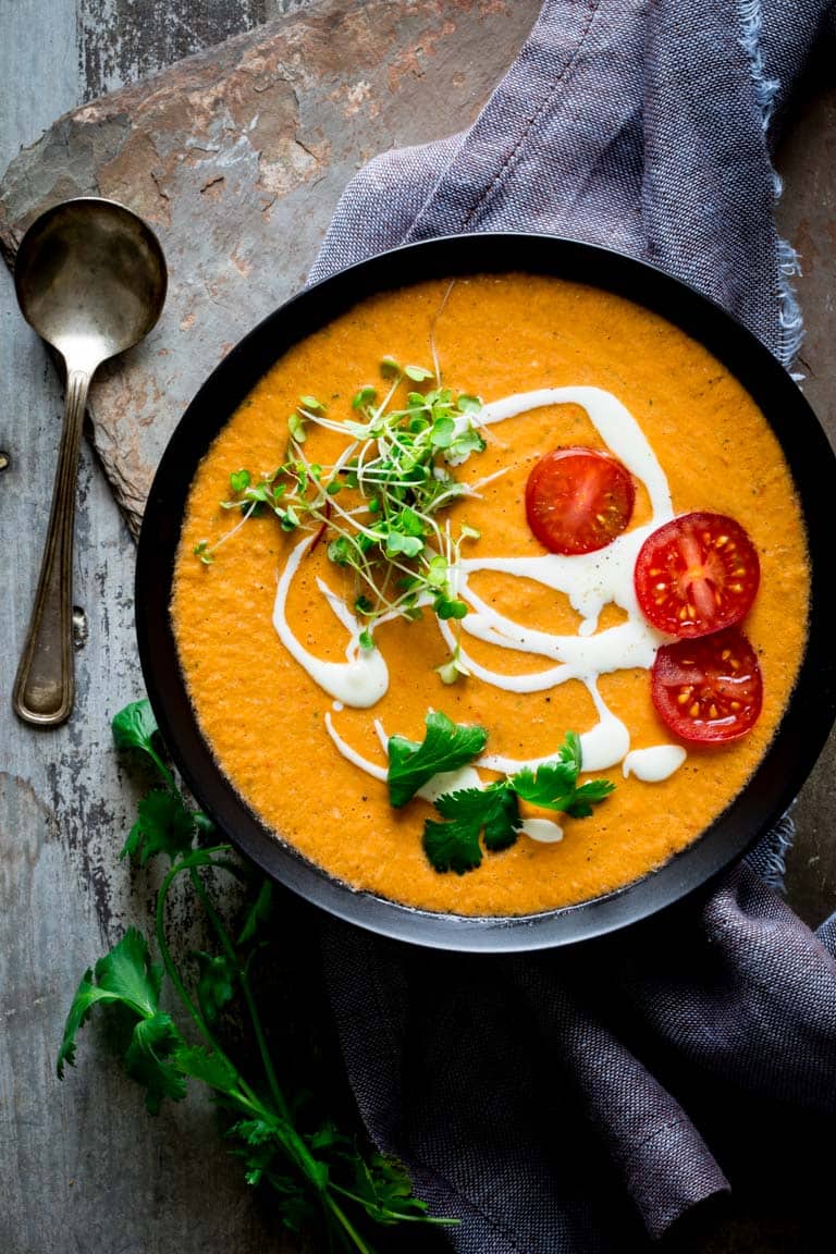 a single bowl of gazpacho with garnishes