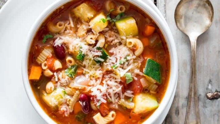 minestrone soup in a white bowl on a gray background