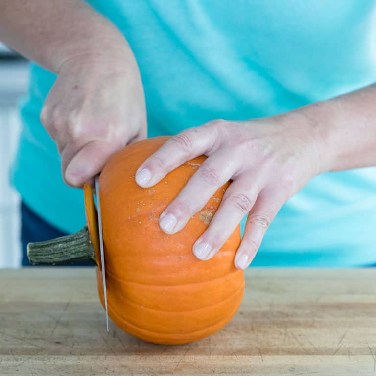 cut the top and bottom off the pie pumpkin to make a level cutting surface.