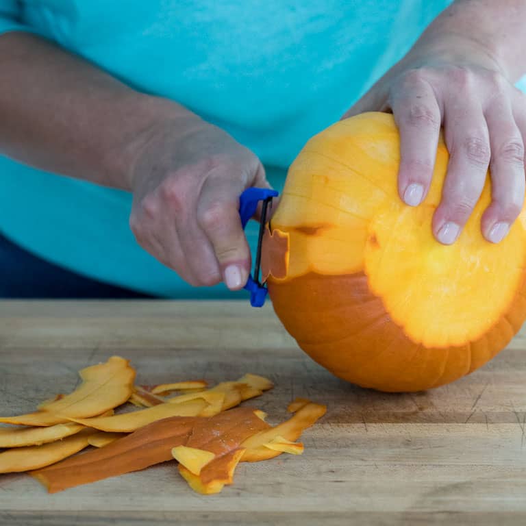 Peel a pie pumpkin with a sharp vegetable peeler
