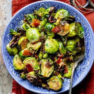 closeup of the roasted brussels sprouts in a blue bowl