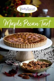 pecan tart on a table with nuts and leaves