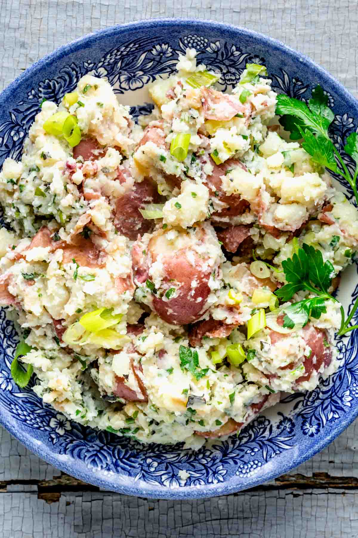 closeup of the red-skinned mashed potatoes in a blue bowl