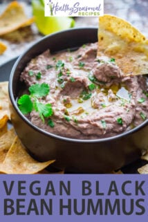 chip dipped in black bean hummus