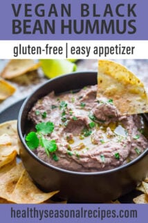 chip dipped in black bean hummus