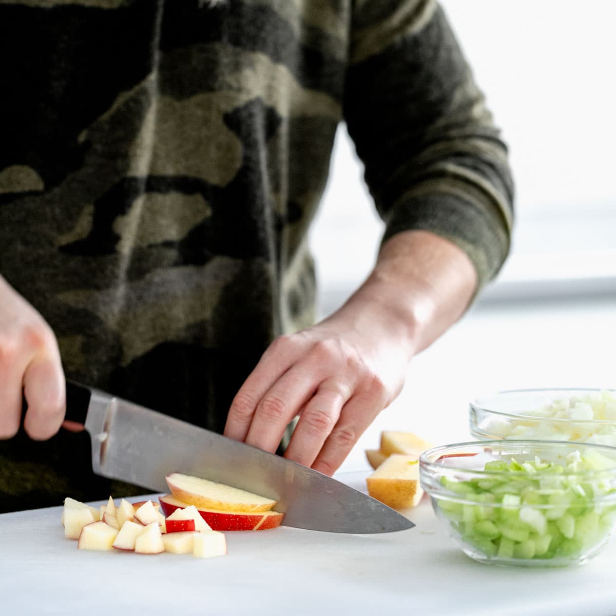 Cutting apples vegetables for go with mussels