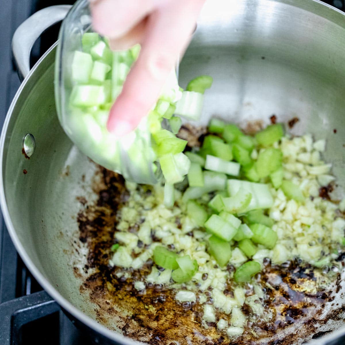 Add garlic and celery to the pot to cook mussels