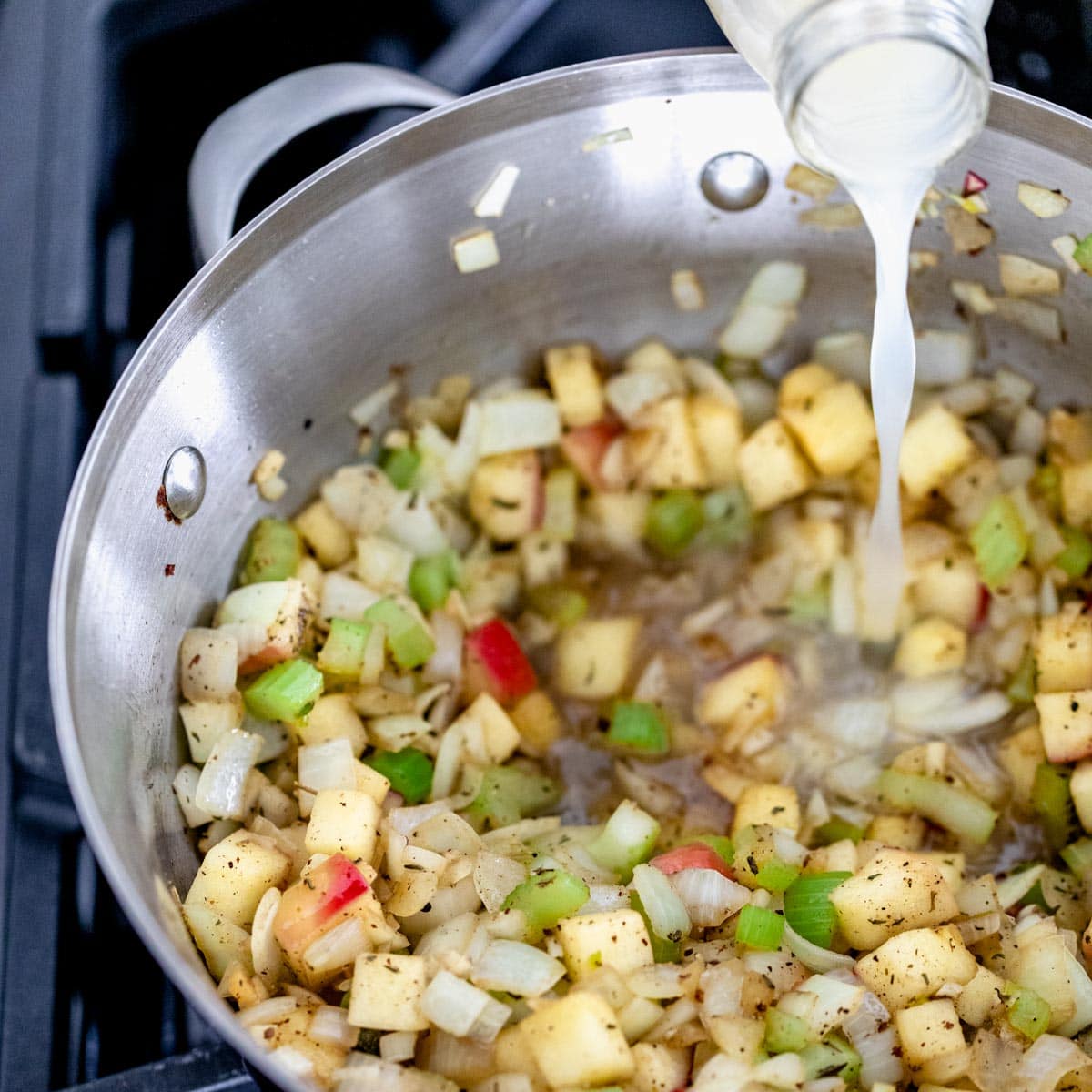 Adding clam juice to sauteed veggies for cooking mussels. How to cook mussels.