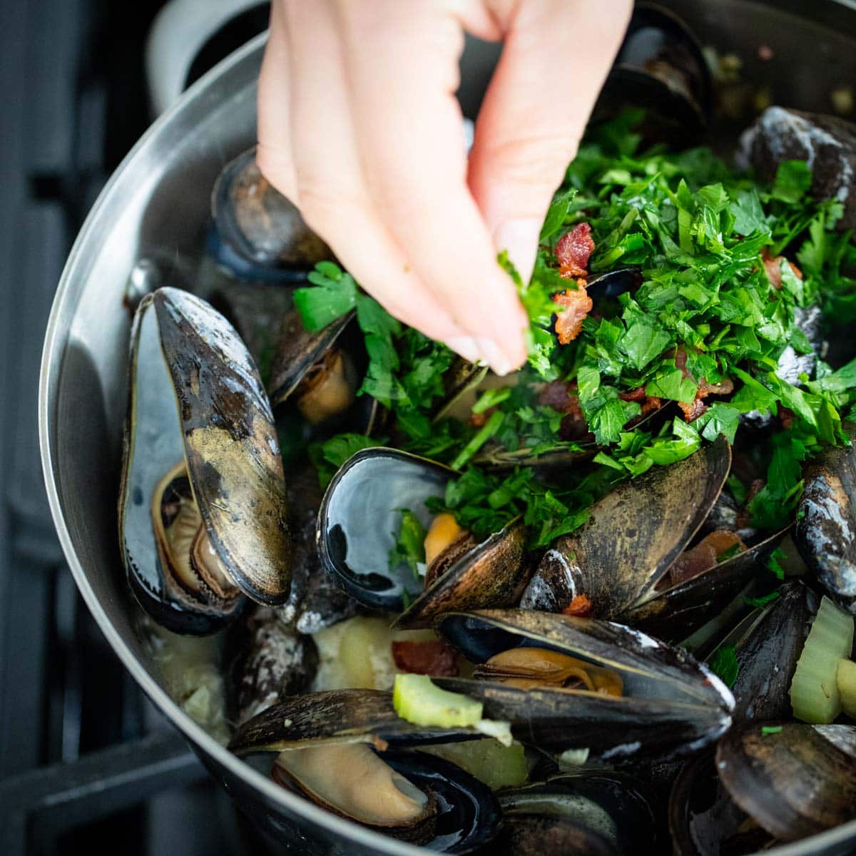 Add parsley and bacon after the mussels have cooked